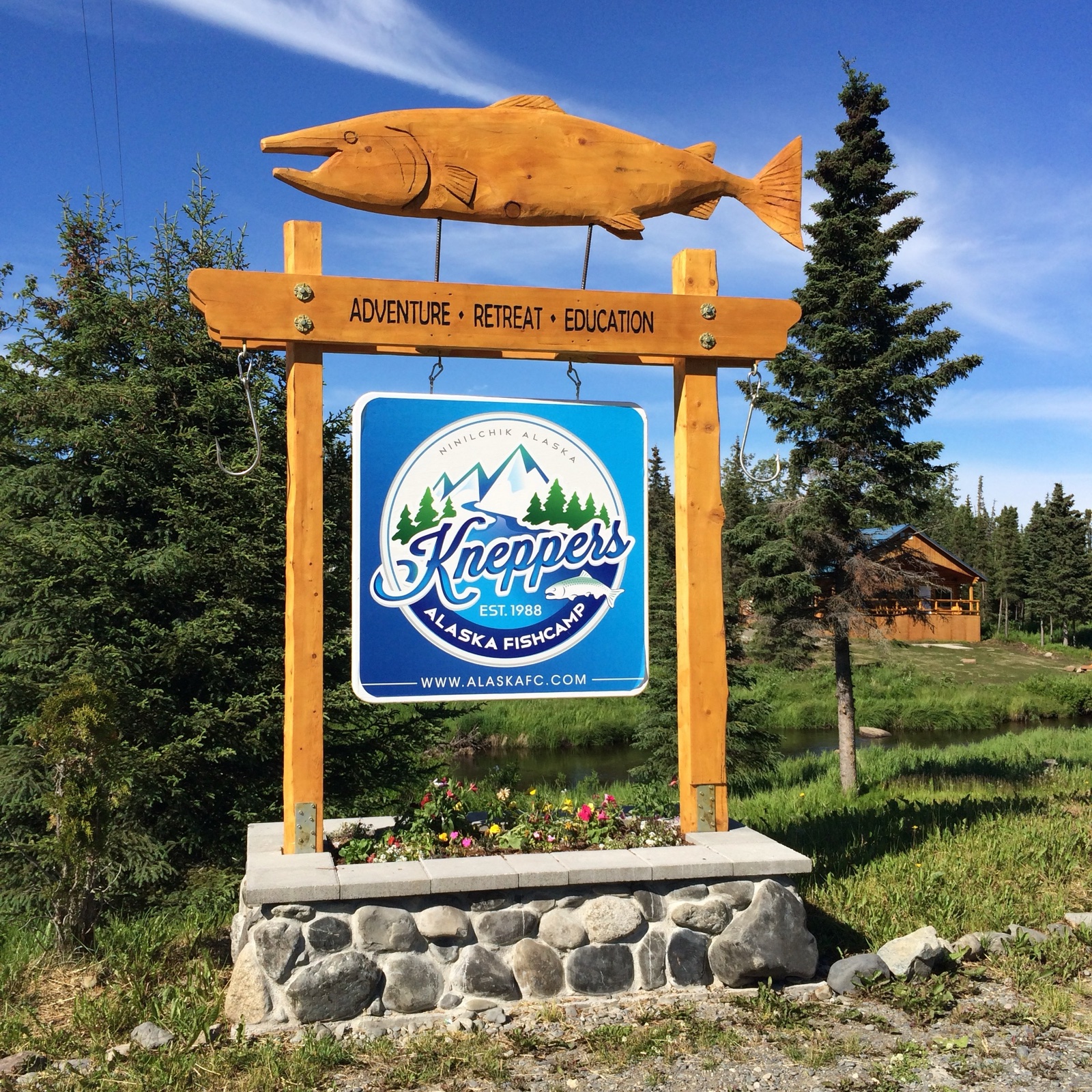 The carved KAFC sign at the entrance: Adventure · Retreat · Education